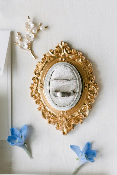 Wedding detail with a gold frame and blue flowers