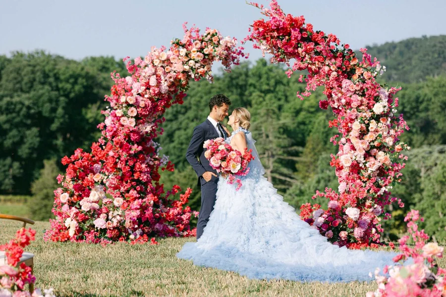 Couple in front of a floral arch photographed by Get Ready Photo